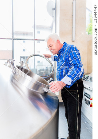 Brewer in brewhouse of beer brewery Brewer in brewhouse of beer brewery 13944447