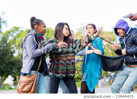 Group of girls being threatened with gun by robber Group of girls being threatened with gun by robber 13944455