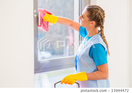 Cleaning lady with cloth at window 13944472