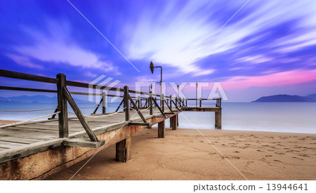 Long exposure of colorful sunrise and wooden pier Long exposure of colorful sunrise and wooden pier 13944641