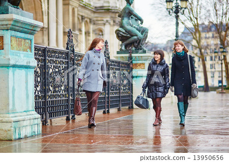 Three cheerful girls walking together in Paris Three cheerful girls walking together in Paris 13950656