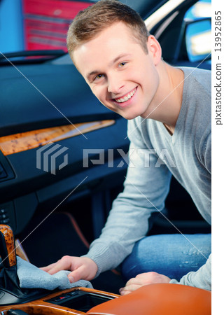 Handsome man cleaning his car Handsome man cleaning his car 13952865
