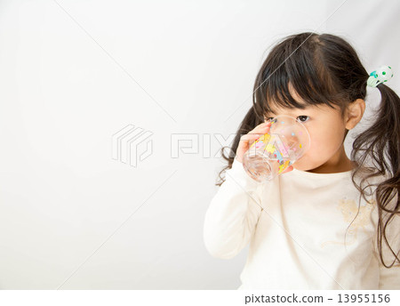 A girl drinking water with a cup 13955156