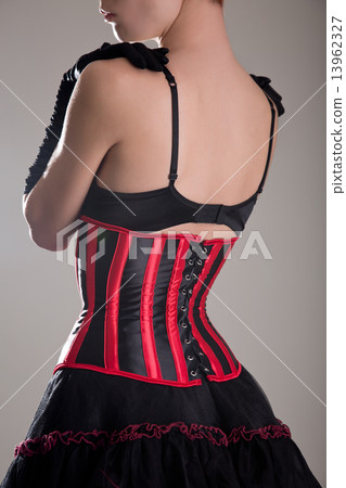 Back view of beautiful woman in corset and bra embracing herself 13962327