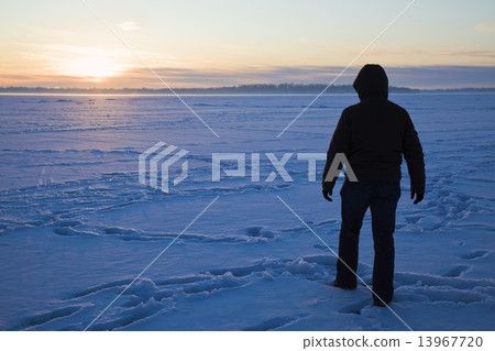 Silhouette of a fisherman walking on the lake 13967720