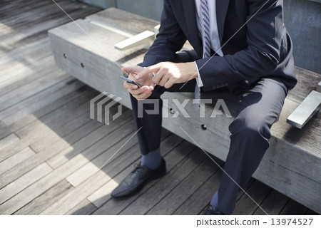 Businesss Man checking messages on his smart phone 13974527