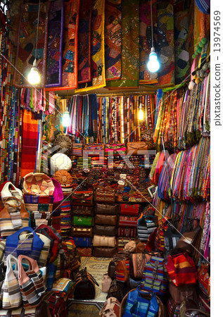 Marquesh souk shops selling colorful cloth products 13974569