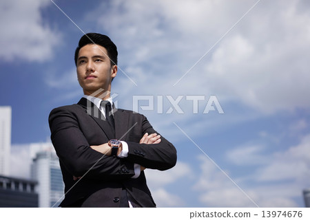 Young confident Asian young man standing proudly 13974676