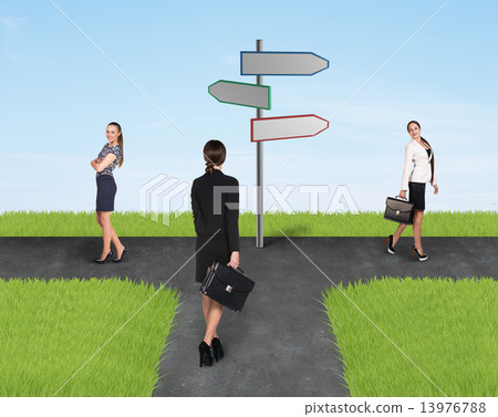 Three usinesswomen standing near sign  13976788