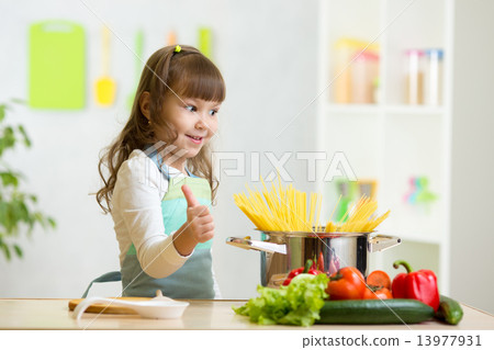 child girl playing cook and preparing spaghetti 13977931
