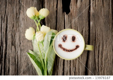 Wood background and happy coffee cup with spring flowers. 13978187