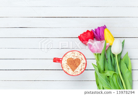 Cappuccino near tulips 13978294