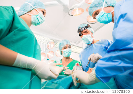 Surgeons in operating room in emergency 13978300