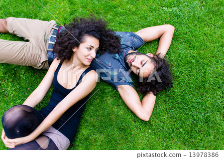 Latin Couple on meadow sleeping in summer Latin Couple on meadow sleeping in summer 13978386
