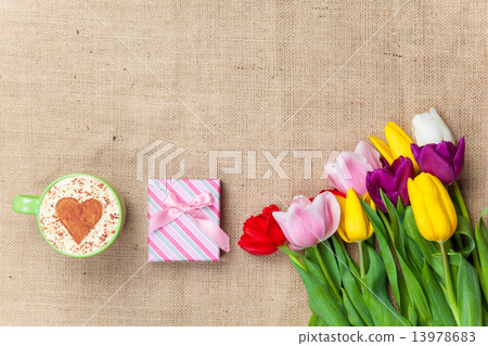 Cappuccino and gift box near flowers Cappuccino and gift box near flowers 13978683