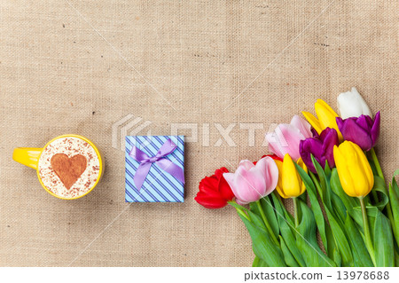 Cappuccino and gift box near flowers 13978688