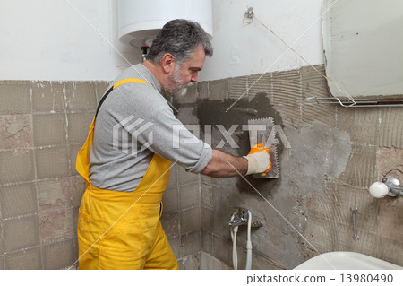 Home renovation, mason fixing wall 13980490