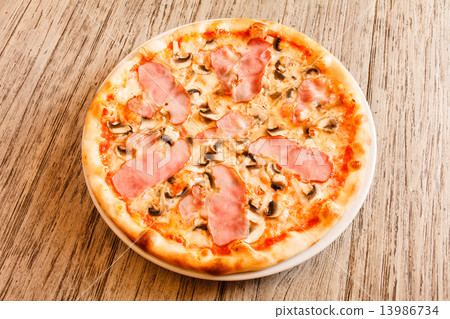 pizza on wooden background 13986734