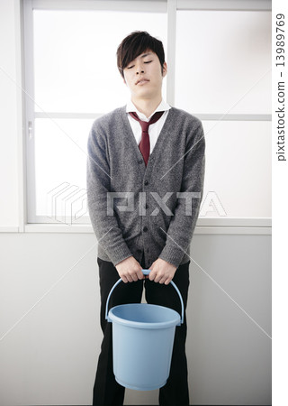 Boys students who stand with a bucket 13989769