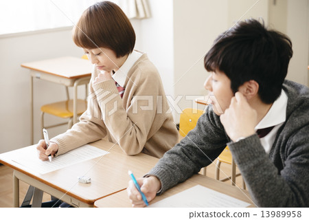 Male student cheating 13989958