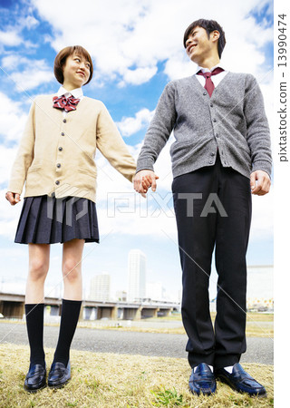 Student couple connecting hands Student couple connecting hands 13990474