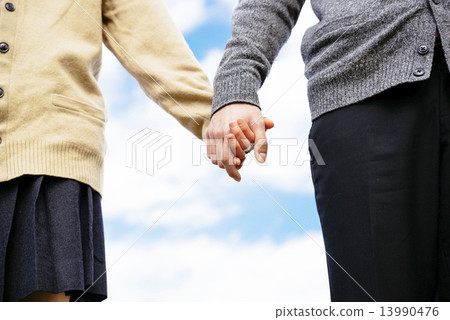 Student couple connecting hands Student couple connecting hands 13990476