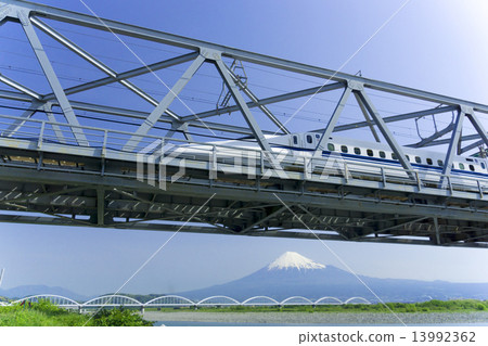 Shinkansen traveling at high speed with Mt. Fuji and the Iron Bridge 13992362