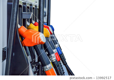 Horizontal shot of some fuel pumps at a gas station 13992517