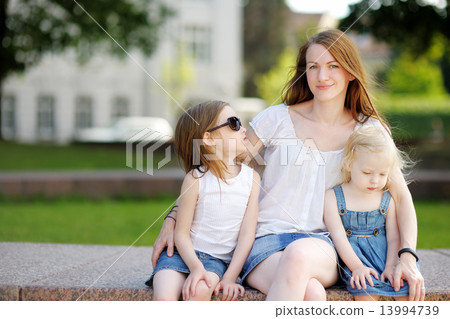 Young mother and her daughters outdoors at summer 13994739