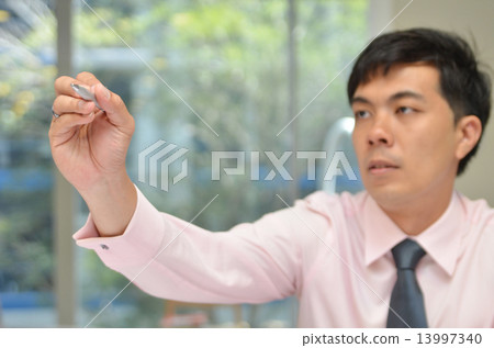 Handsome Business man writing with pen in the air 13997340