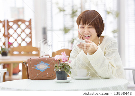 Short Hair College Student Relaxing At The Cafe Stock Photo