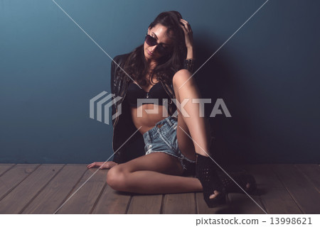 Stunning young woman with dark hair posing floor perfect body looking down through sunglasses. Stunning young woman with dark hair posing floor perfect body looking down through sunglasses. 13998621