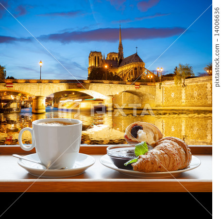 Coffee with croissants against cathedral Notre Dame in Paris, France Coffee with croissants against cathedral Notre Dame in Paris, France 14006636