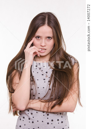 Portrait of serious young girl with hand near face 14007272