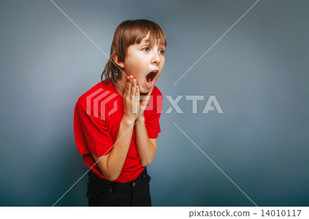 boy teenager European appearance in a red shirt holding hands at boy teenager European appearance in a red shirt holding hands at 14010117