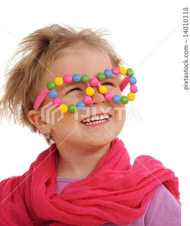 Portrait of cute little girl wearing funny glasses, decorated with colorful sweets, smarties,candies Portrait of cute little girl wearing funny glasses, decorated with colorful sweets, smarties,candies 14010118