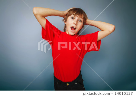 boy teenager European appearance in a red shirt put his hands be boy teenager European appearance in a red shirt put his hands be 14010137