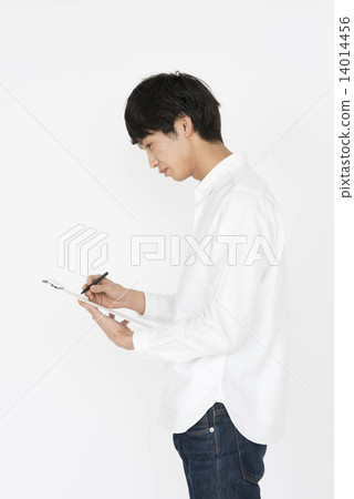 A young man with a white shirt to write something A young man with a white shirt to write something 14014456