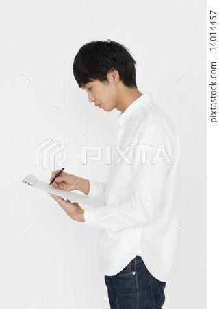 A young man with a white shirt to write something A young man with a white shirt to write something 14014457