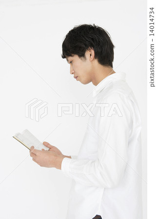 A person reading a notebook with a serious look A person reading a notebook with a serious look 14014734