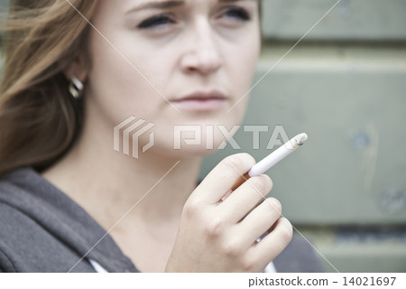 Close Up Of Teenage Girl Smoking Cigarette Outdoors 14021697