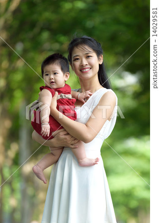 Chinese mother carrying a child in a park 14029581