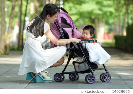 Chinese mother with baby in a stroller Chinese mother with baby in a stroller 14029605