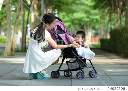Chinese mother with baby in a stroller Chinese mother with baby in a stroller 14029606