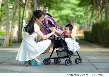 Chinese mother with baby in a stroller Chinese mother with baby in a stroller 14029612