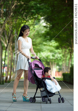 Chinese mother pushing baby in a stroller 14029631