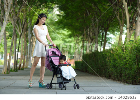Chinese mother pushing baby in a stroller 14029632