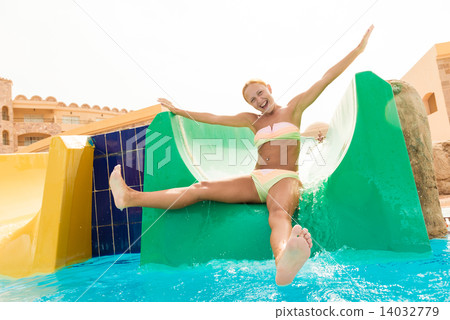 Young woman on a waterslide Young woman on a waterslide 14032779