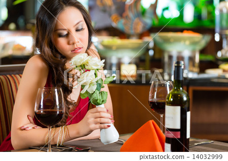 Chinese woman waiting in restaurant for date Chinese woman waiting in restaurant for date 14032999