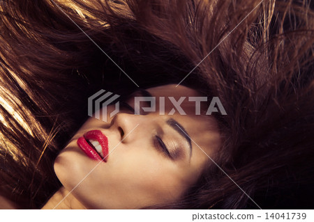 Young woman with red lips and flowing hair Young woman with red lips and flowing hair 14041739